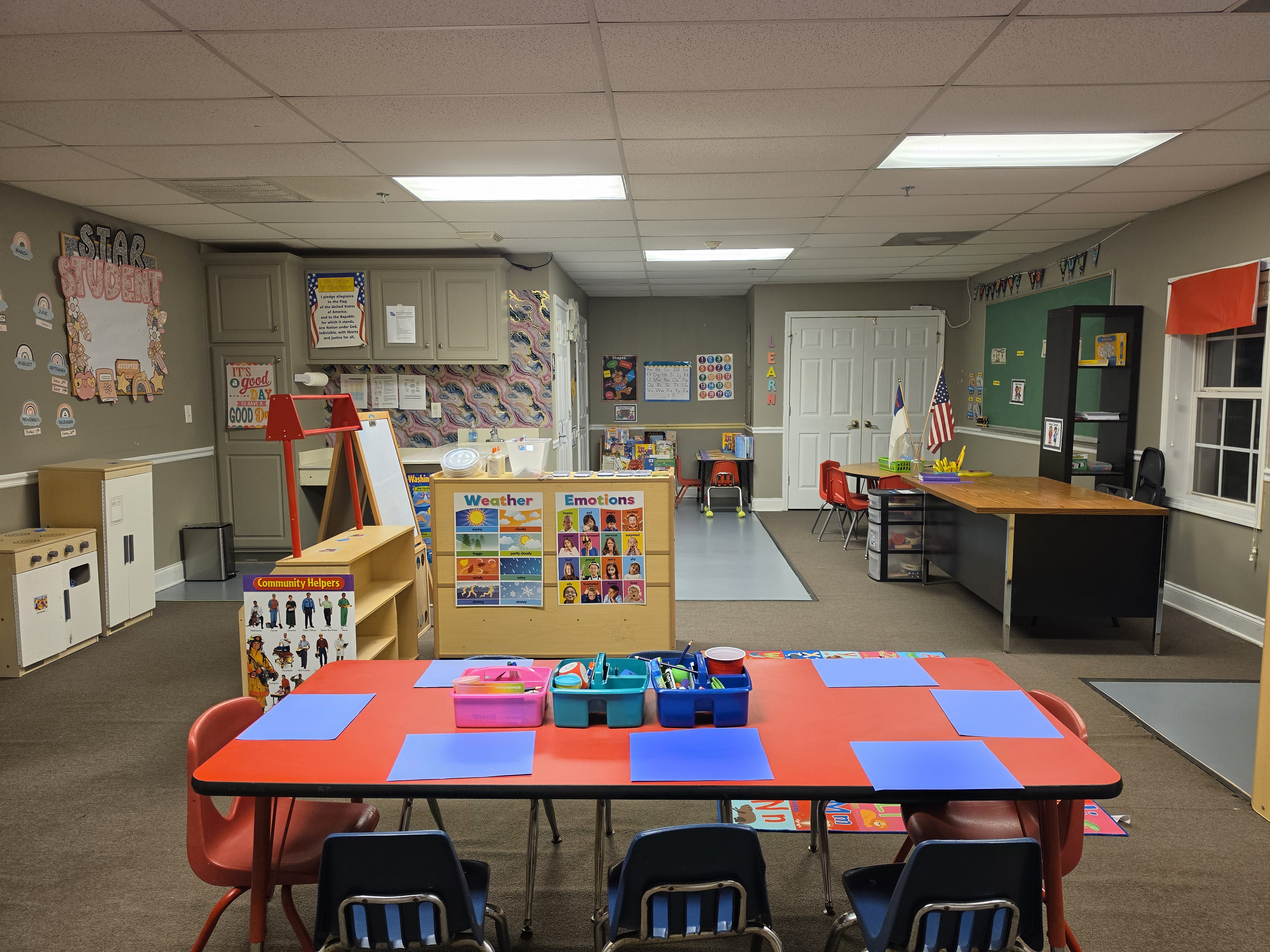 A bright BCA elementary classroom with activity tables and learning centers